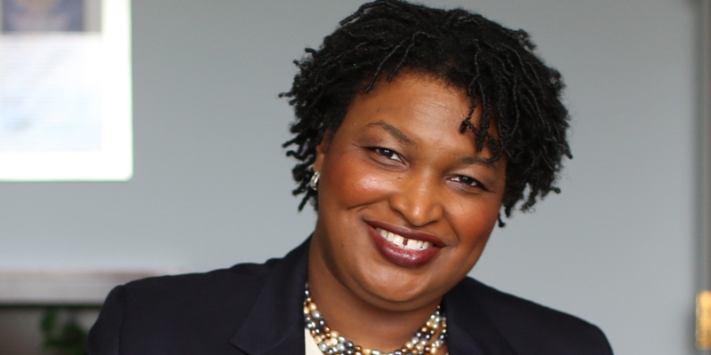 Headshot of Stacey Abrams (with short black textured hair and brown skin)