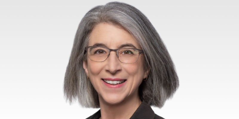 Headshot of Cindy Cohn (with grey bob, eyeglasses, and black jacket)
