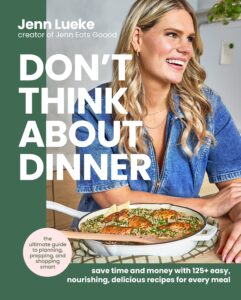 Book cover of “DON’T THINK ABOUT DINNER: save time and money with 125+ easy, nourishing, delicious recipes for every meal” by Jenn Lueke, creator of Jenn Eats Goood. The cover features a photo of Jenn smiling and posing next to a meal in a white skillet, garnished with herbs and lemon. A pink circle is in the lower left corner with text reading “the ultimate guide to planning, prepping, and shopping smart.”