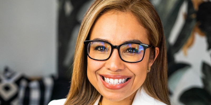 Headshot of Dr. Bertha Hidalgo (with tan skin, brown hair, and glasses)