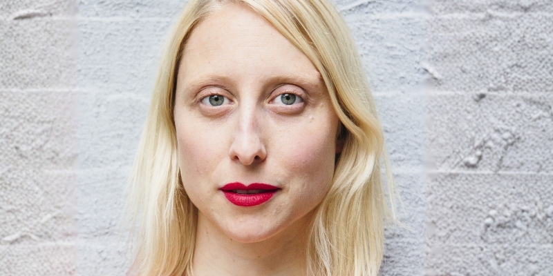 Headshot of Emma Straub (with fair skin, long blonde hair, and red lipstick)