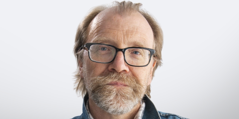 Headshot of George Saunders (with eyeglasses, grey/blonde beard)