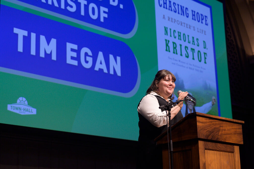 Kate Nagle-Caraluzzo standing at podium