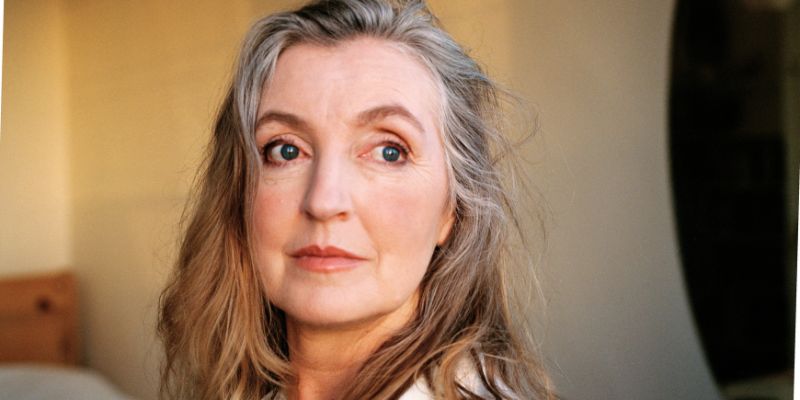 Rebecca Solnit, with long gray hair, looks at the camera