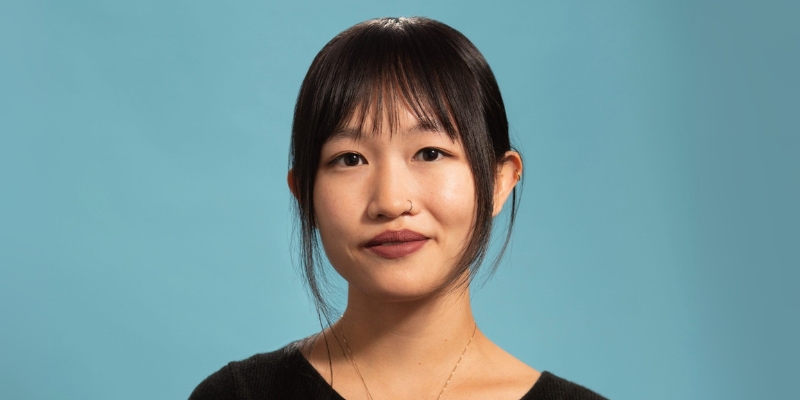 Headshot of R.F. Kuang (with light skin, black ponytail, and blunt bangs)