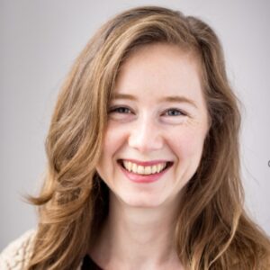 Headshot of Shannon Grimes (with fair skin and long light brown hair)