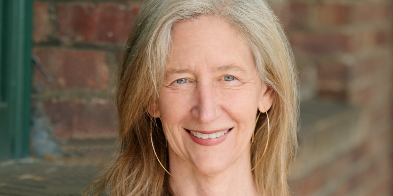 Headshot of Susan Magsamen (with fair skin, long blonde hair, and hoop earrings)