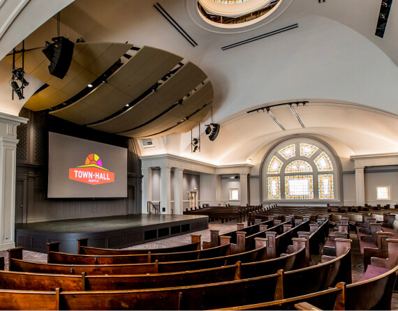 Photo of the Great Hall, a small theater with wood bench seating