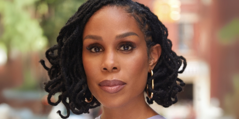Headshot of Dr. Uche Blackstock (with brown skin and black hair twists)
