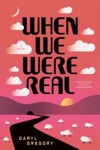 Book cover for When We Were Real by Daryl Gregory. The design features bold black typography against a pink and orange gradient sky with stylized clouds. A winding black road leads toward a sunset over rolling hills, with small white sheep scattered across the landscape.