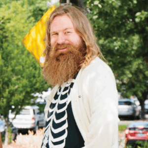 Headshot of Emmett Montgomery (with blond hair and long beard)